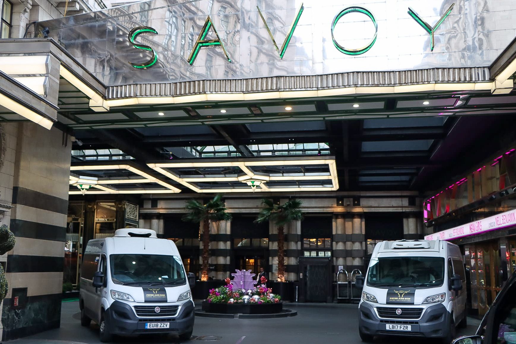 Two Peter and Son vans at the entrance of The Savoy